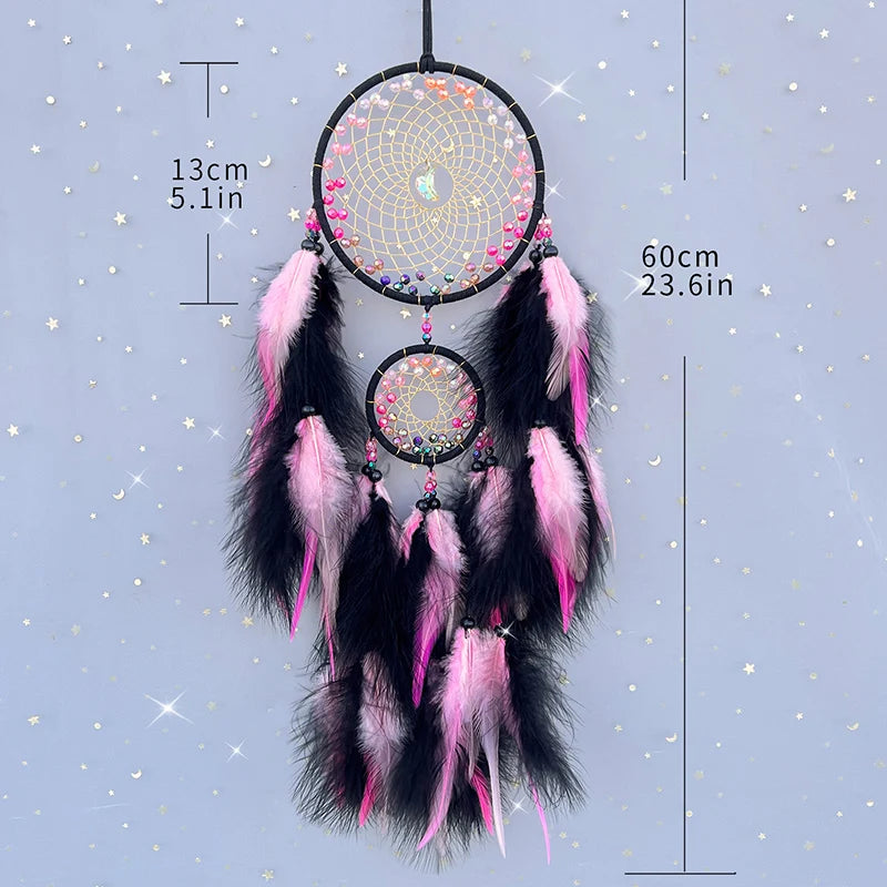 Dreamcatcher with pink and black feathers on a starry background