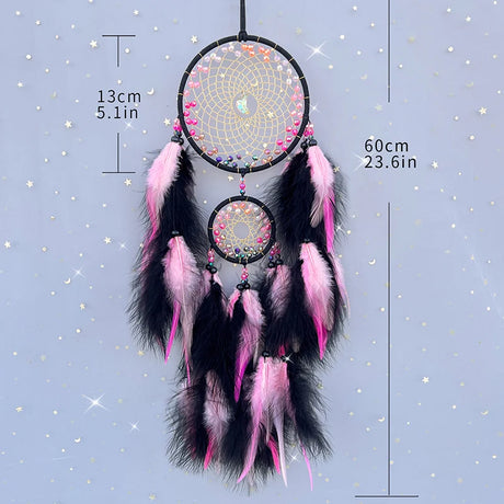 Dreamcatcher with pink and black feathers on a starry background