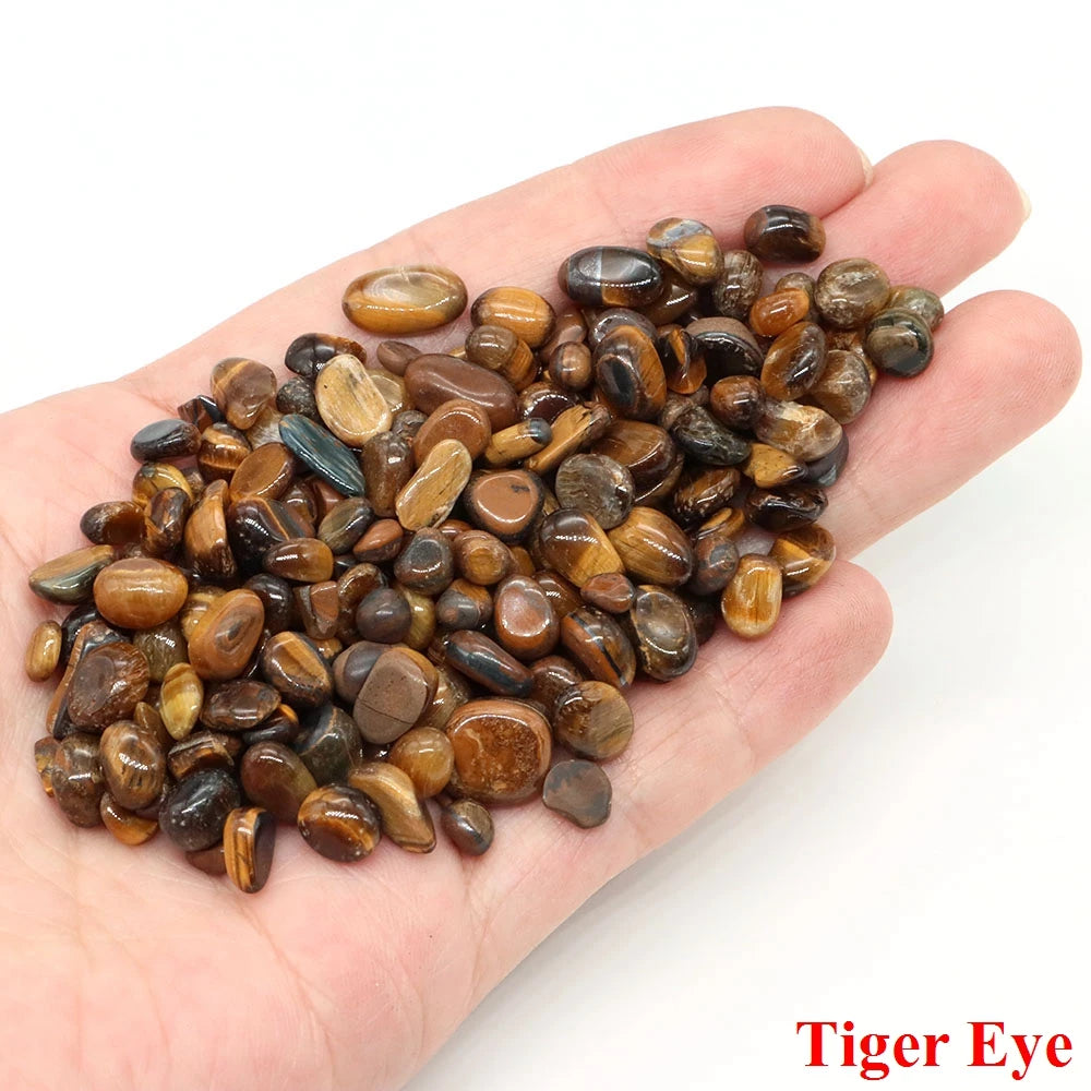 Hand holding a pile of tiger eye stones with 'Tiger Eye' text at the bottom.