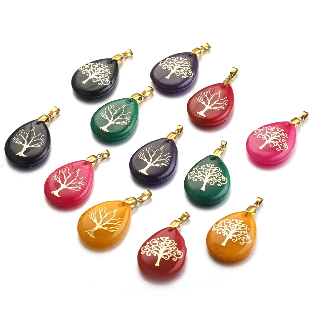 Set of colorful teardrop-shaped pendants with tree designs on a white background