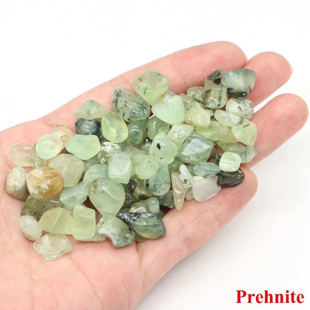 Hand holding a pile of prehnite stones with 'Prehnite' text on a white background