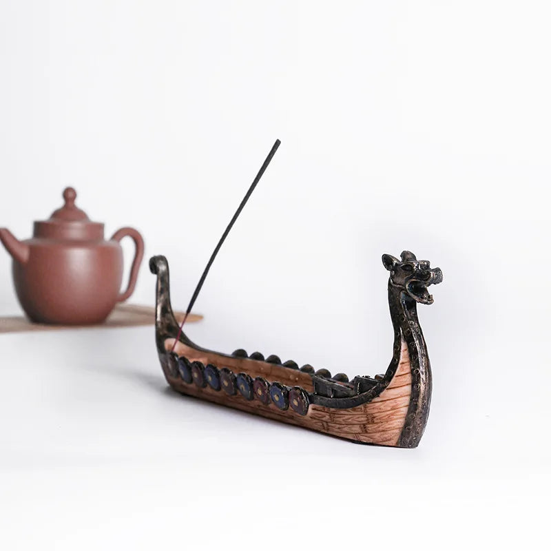 Dragon boat incense burner with incense stick on a white background