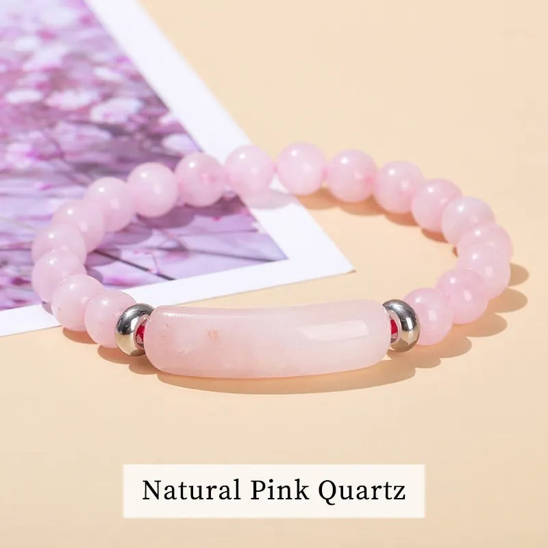 Pink quartz bracelet with silver accents on a beige background