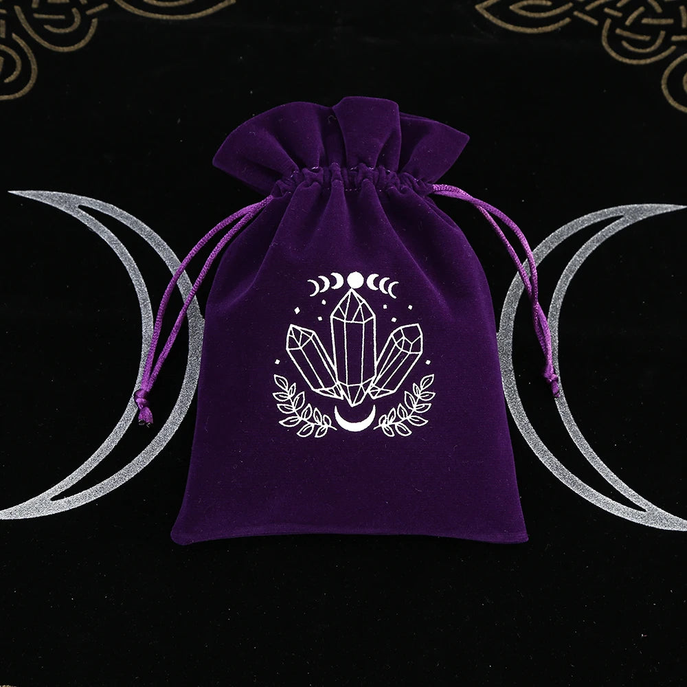 Purple drawstring bag with crystal design on a black background with moon symbols.