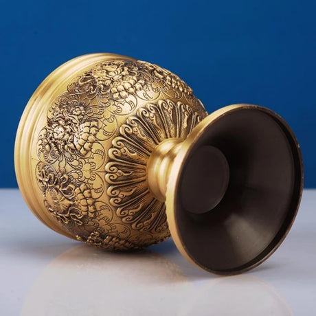 Decorative gold sphere with intricate patterns on a blue background