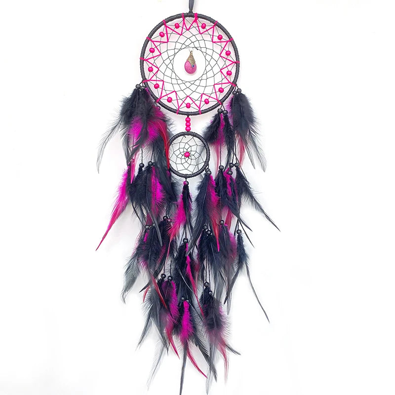 Black and pink dreamcatcher with feathers on a white background