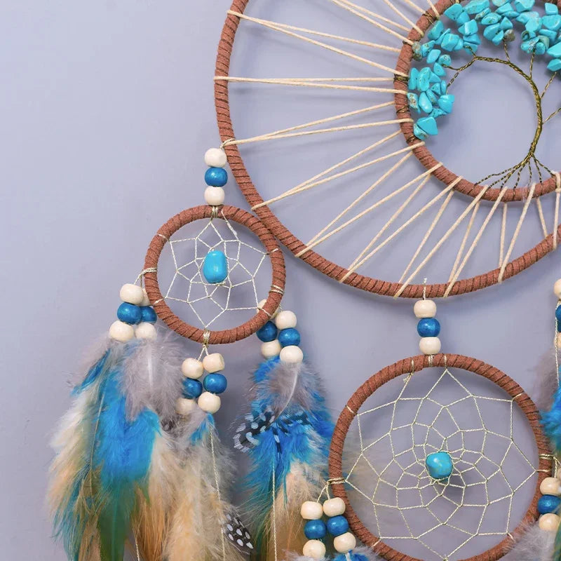 Dreamcatcher with blue and white feathers and beads on a light purple background