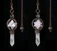 Two crystal pendant necklaces on chains against a black background, with 'Cala Jewelry' logo.