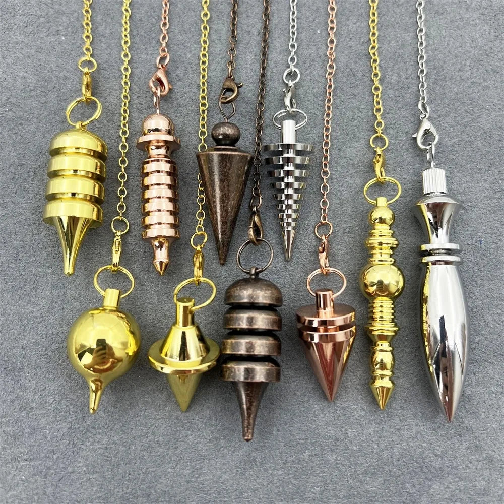 Collection of various metal pendulums on a gray background