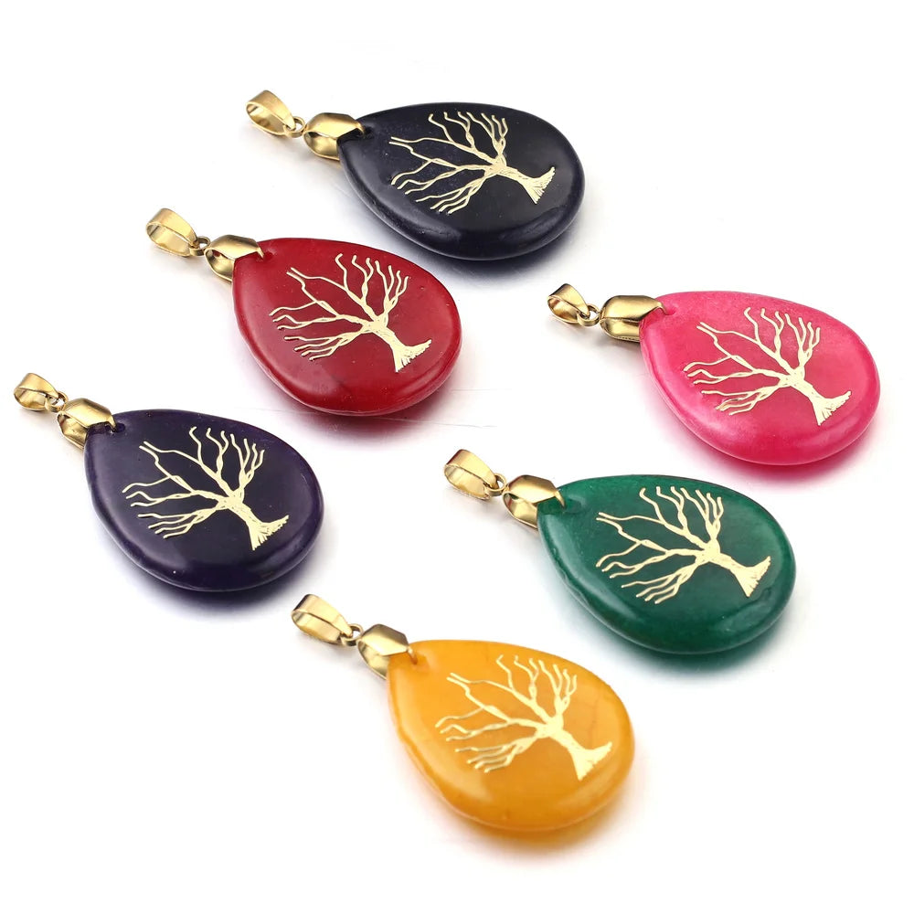 Set of colorful teardrop-shaped pendants with gold tree designs on a white background