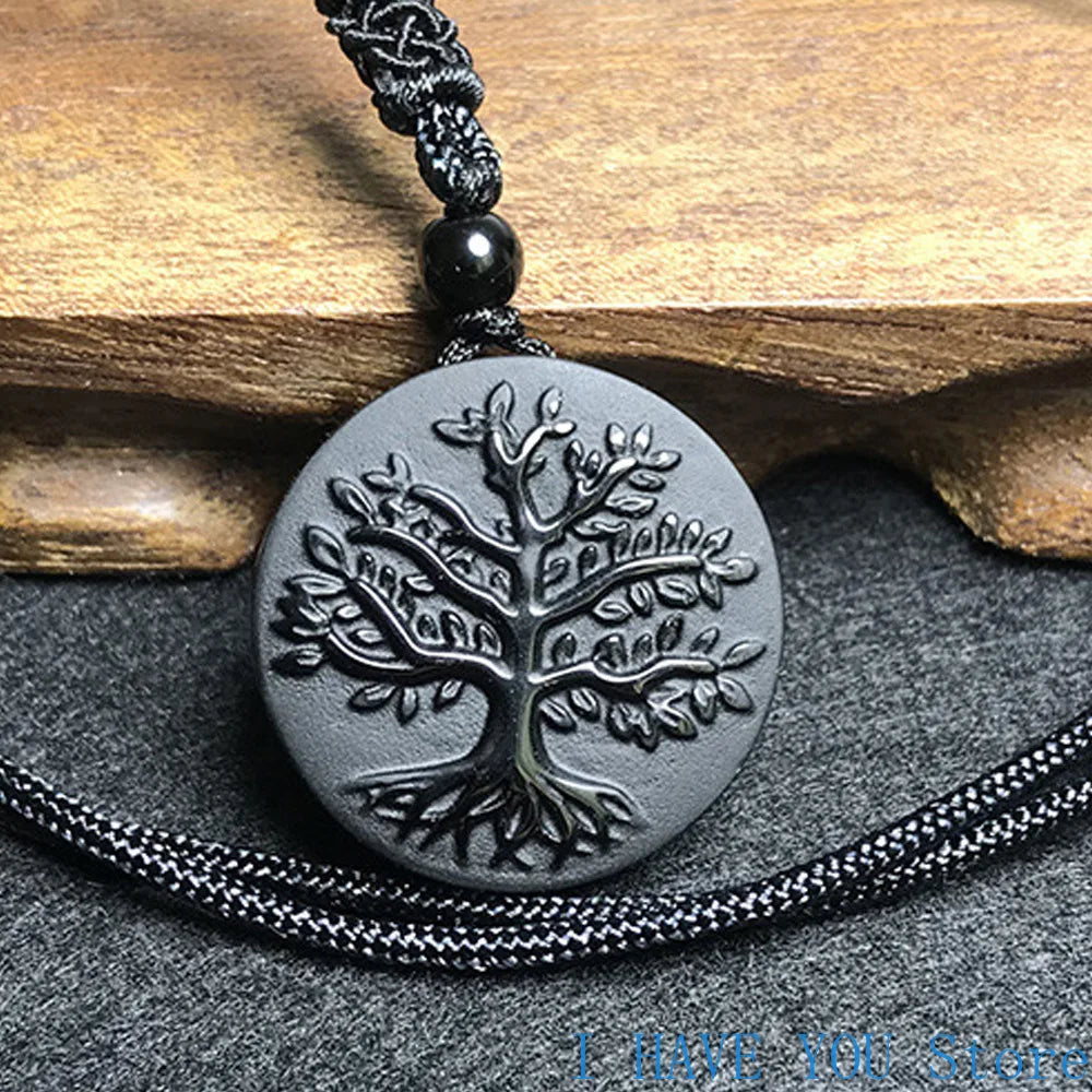 Necklace with a tree of life pendant on a wooden and stone background