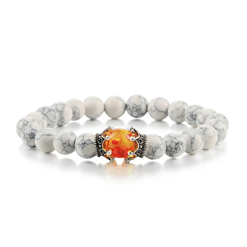 Bracelet with white beads and a central orange stone on a white background