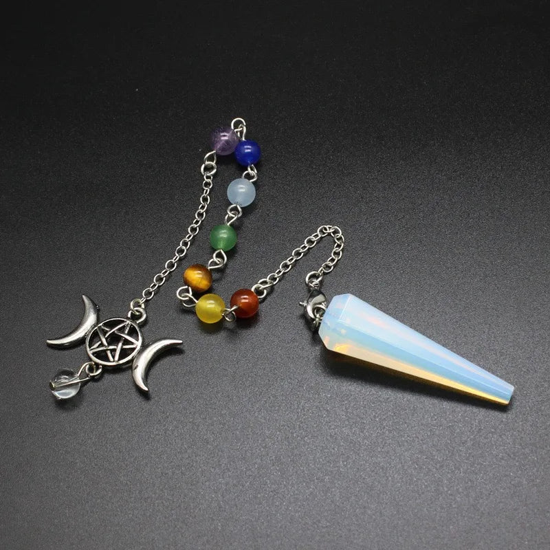Necklace with moon and pentacle charm and chakra beads on a dark background