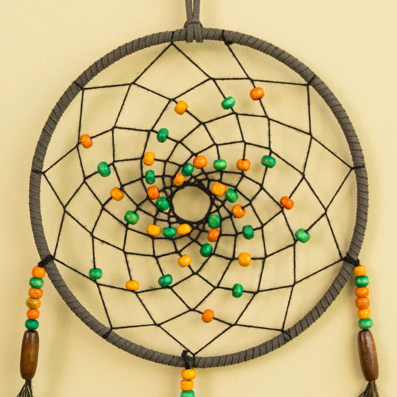 Dreamcatcher with orange and green beads on a beige background