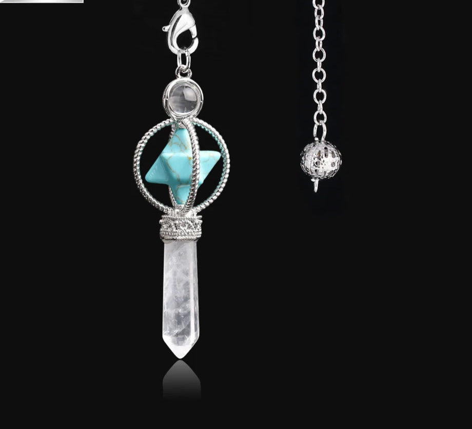 Jewelry pendant with turquoise stone and crystal on a black background