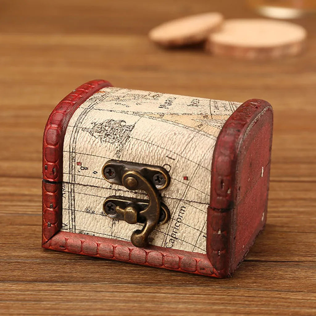 Small wooden treasure chest with map design on a wooden surface