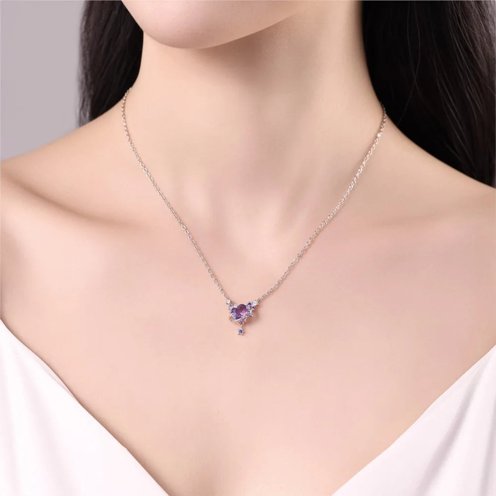 Necklace with a heart-shaped pendant featuring purple gemstones on a mannequin.