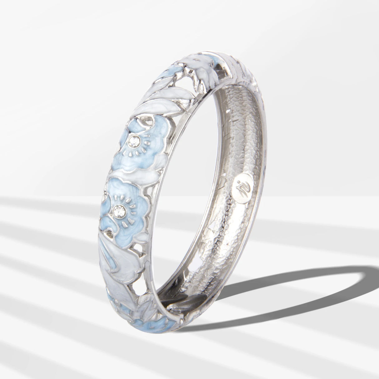 Silver ring with floral design on a white background