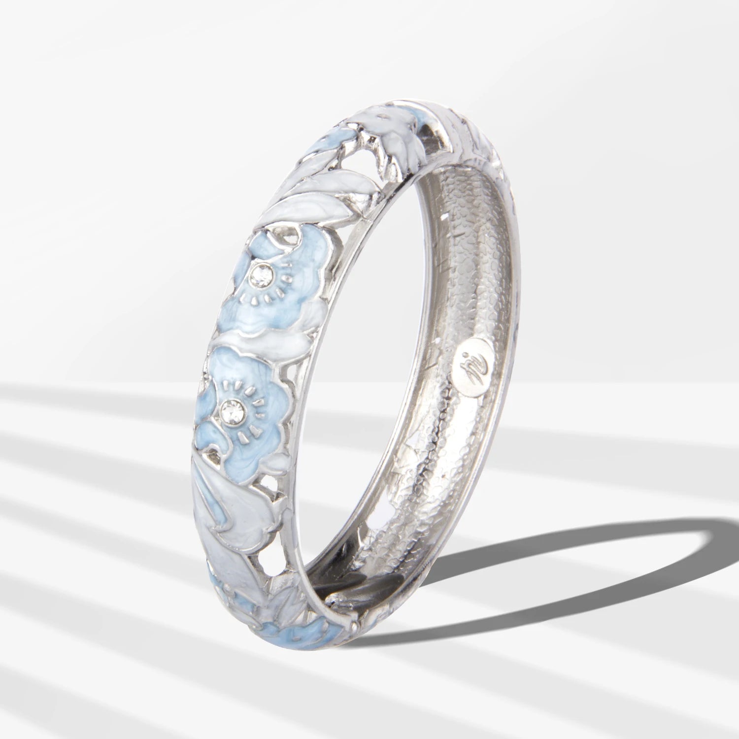 Silver ring with floral design on a white background