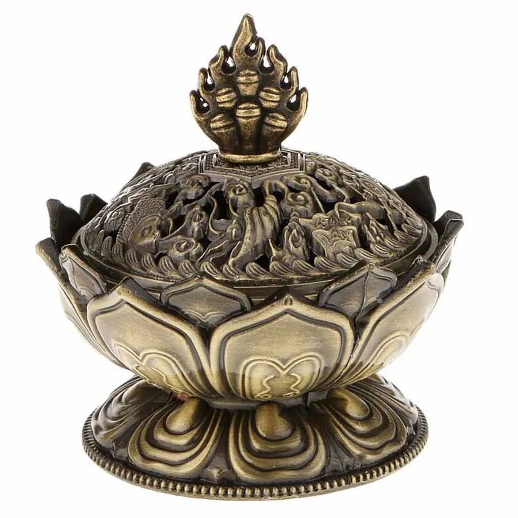 Decorative bronze incense burner with intricate designs on a white background