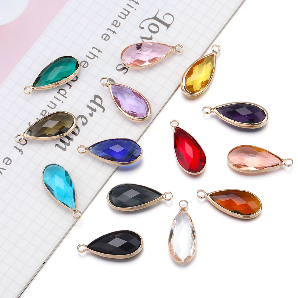 Colorful teardrop-shaped jewelry pendants on a white background