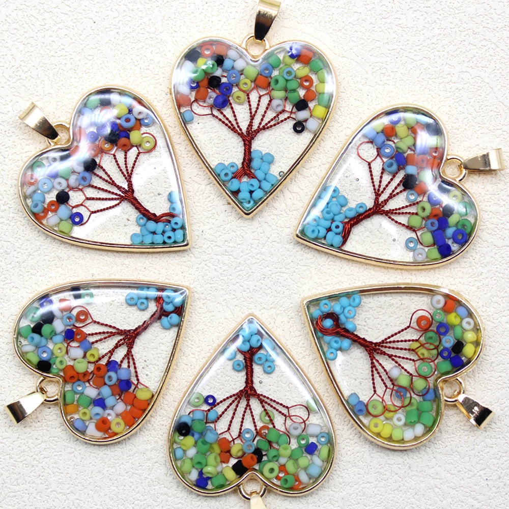 Set of heart-shaped beaded pendants on a white background
