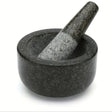 Black stone mortar and pestle on a white background