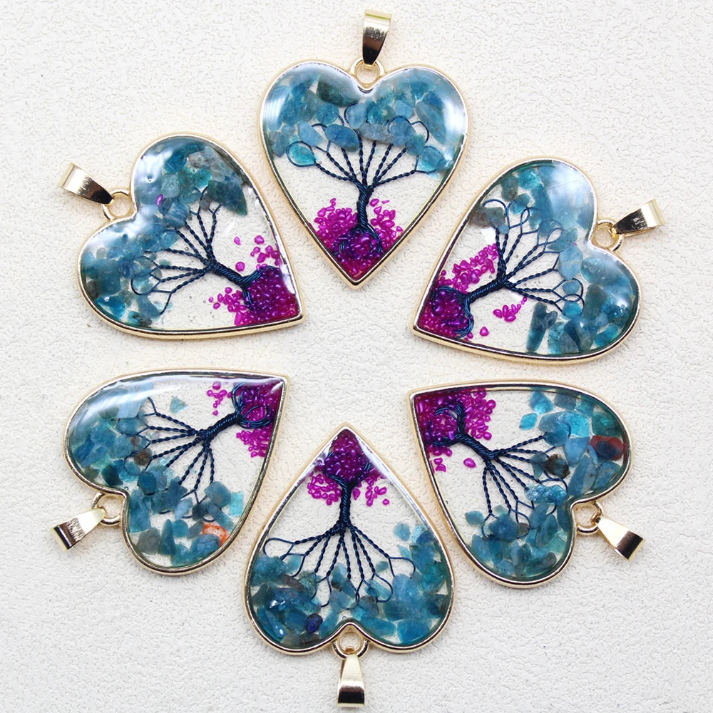 Set of heart-shaped pendants with tree design on a white background