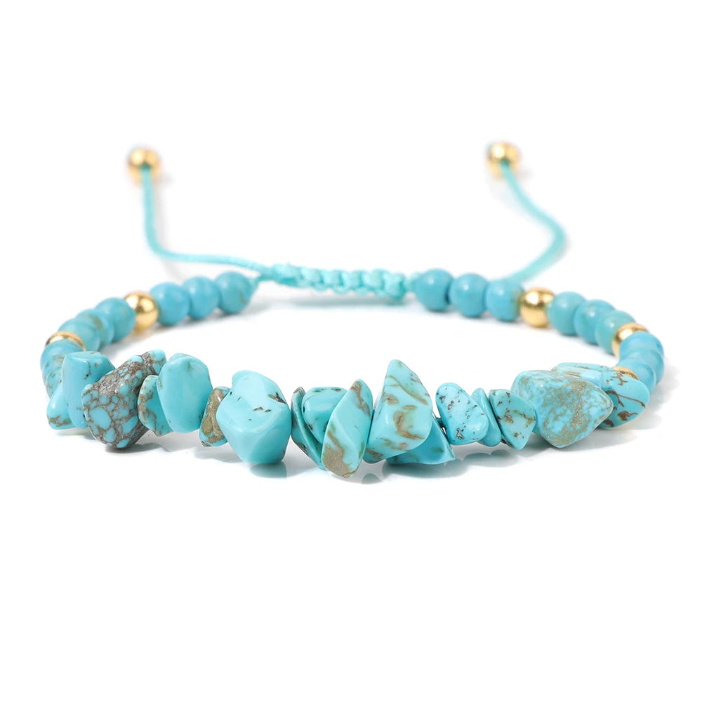 Turquoise beaded bracelet with gold accents on a white background