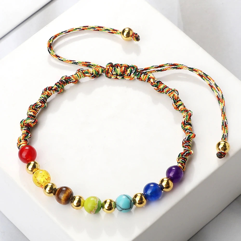 Colorful beaded bracelet with gold accents on a white background