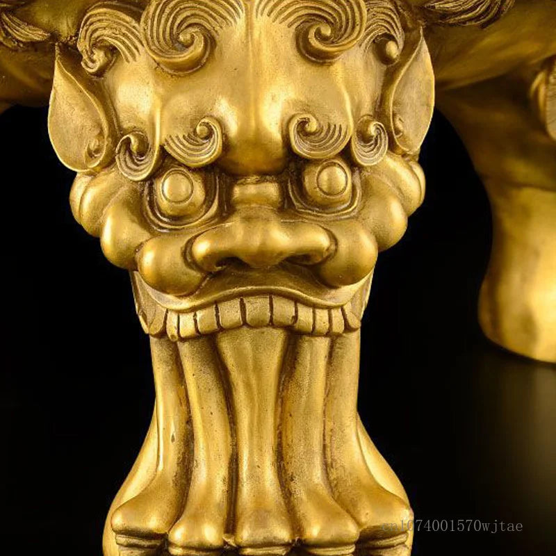 Close-up of a gold lion statue with intricate details on a black background