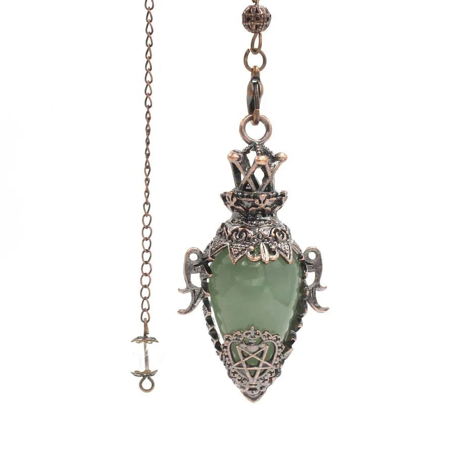 Pendant with green stone and intricate metalwork on a white background