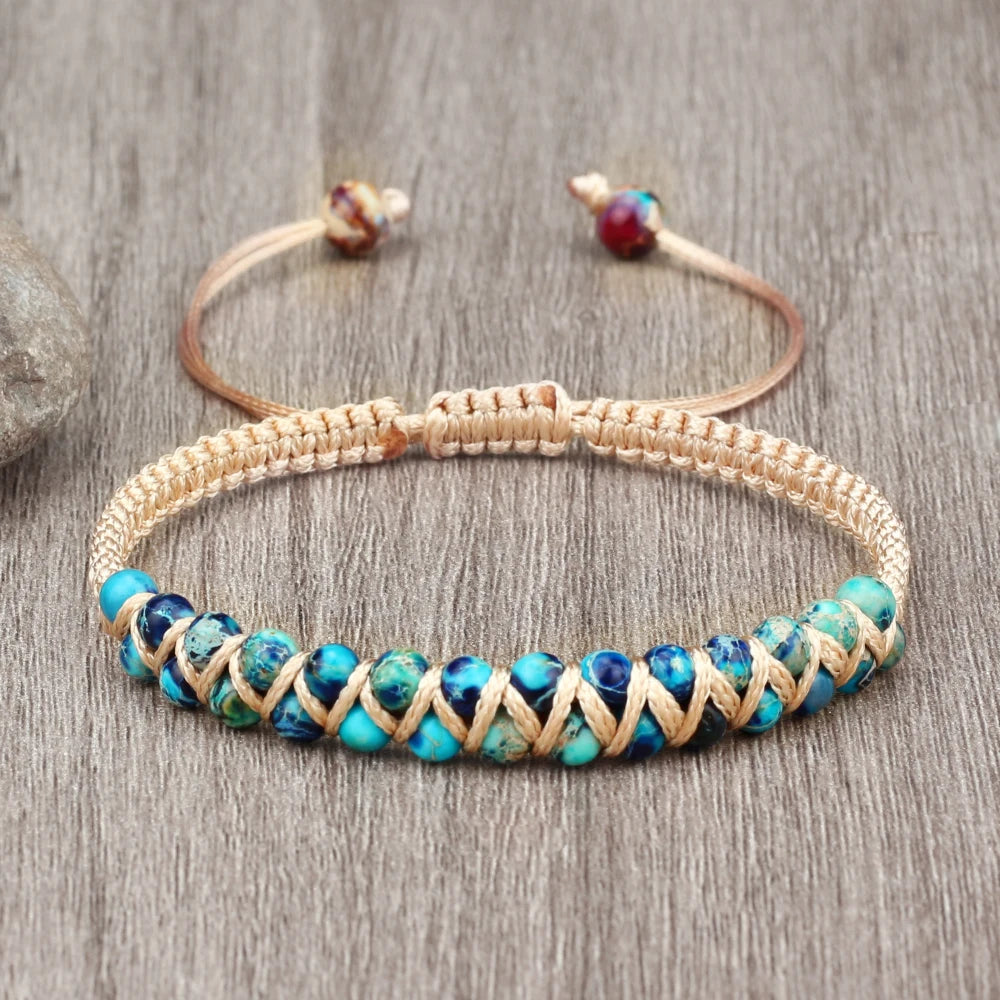 Bracelet with blue beads and woven design on a wooden surface