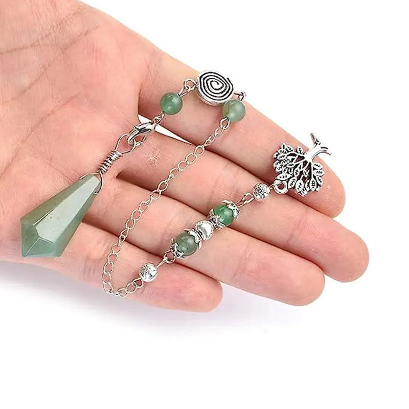Hand holding a silver bracelet with green beads and a peacock feather charm on a white background