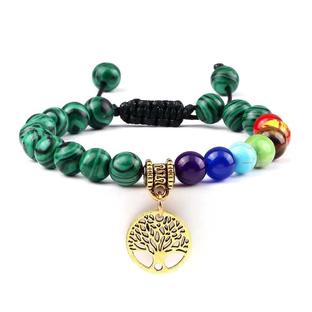 Multicolored beaded bracelet with a gold tree of life charm on a white background