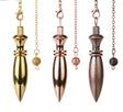 Three metallic pendulums in gold, rose gold, and bronze on white background
