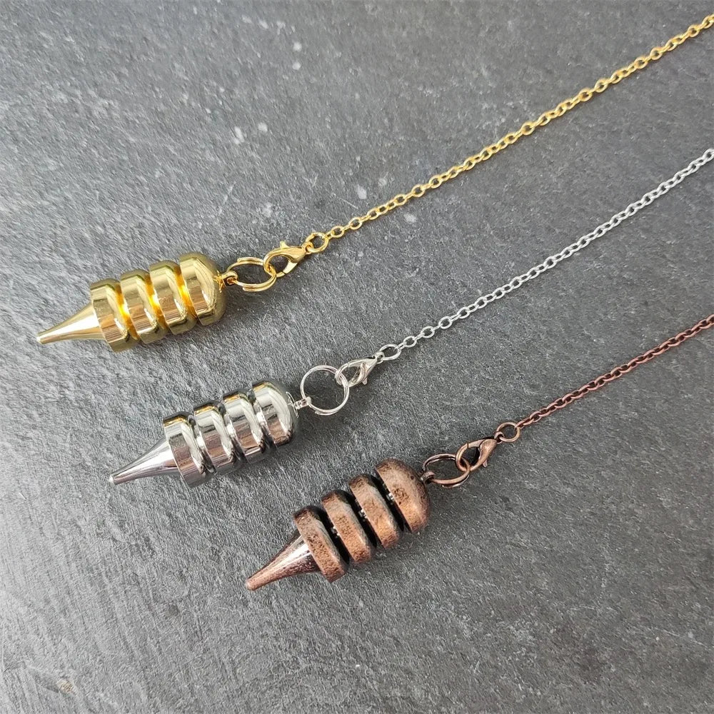 Three necklaces with unique pendant designs on a gray surface