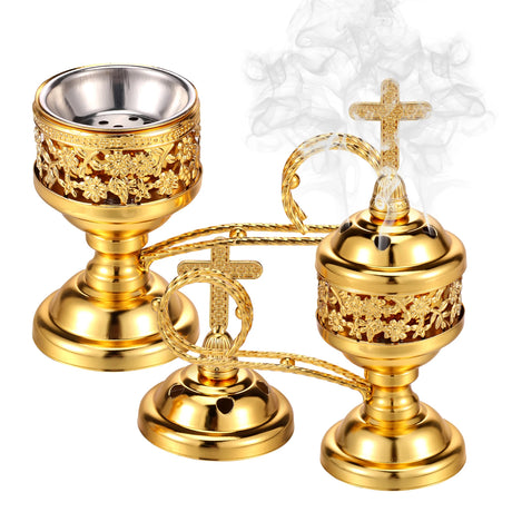 Gold incense burner with intricate designs and a cross on a white background