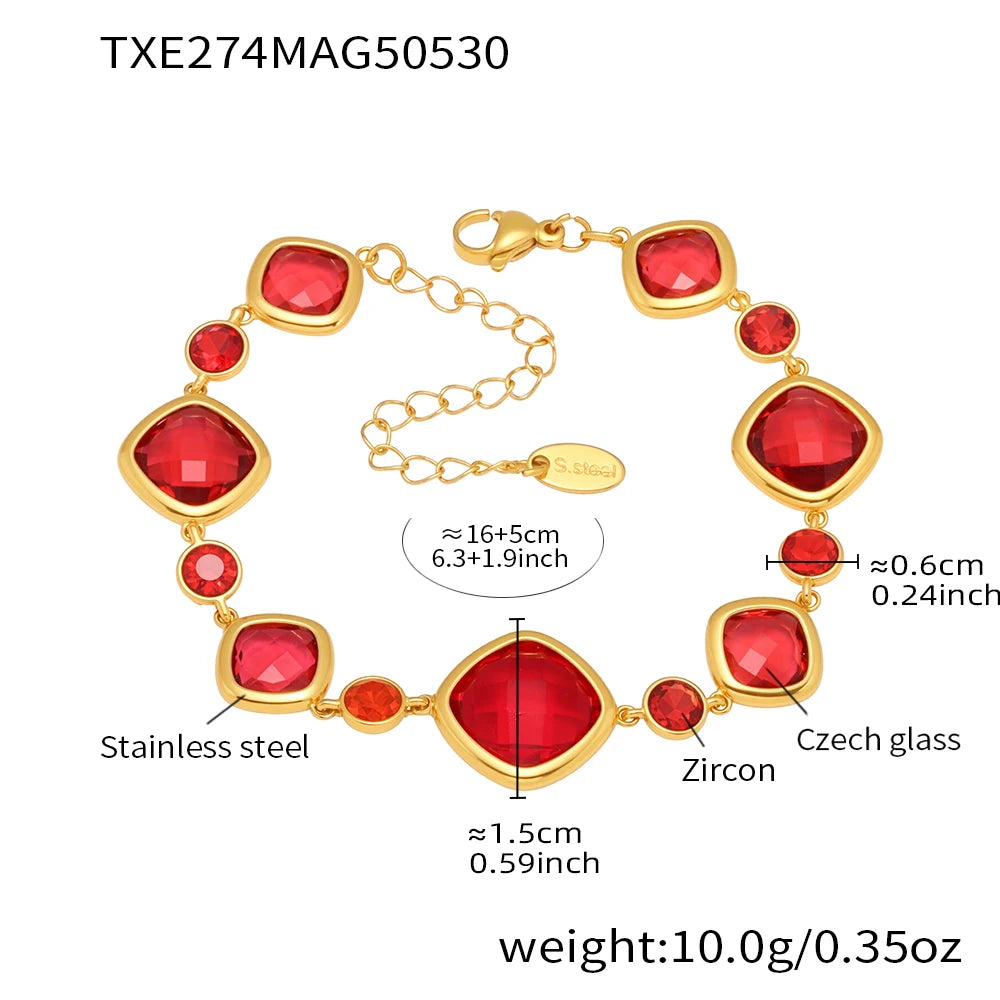 Gold bracelet with red stones and measurements on a white background