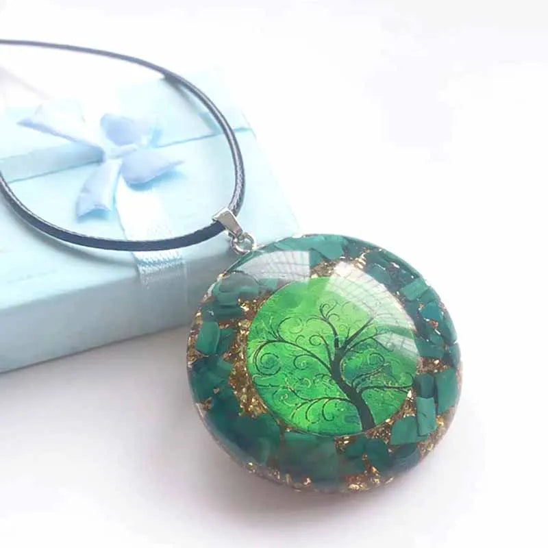 Green tree of life pendant with a magnifying glass on a white background