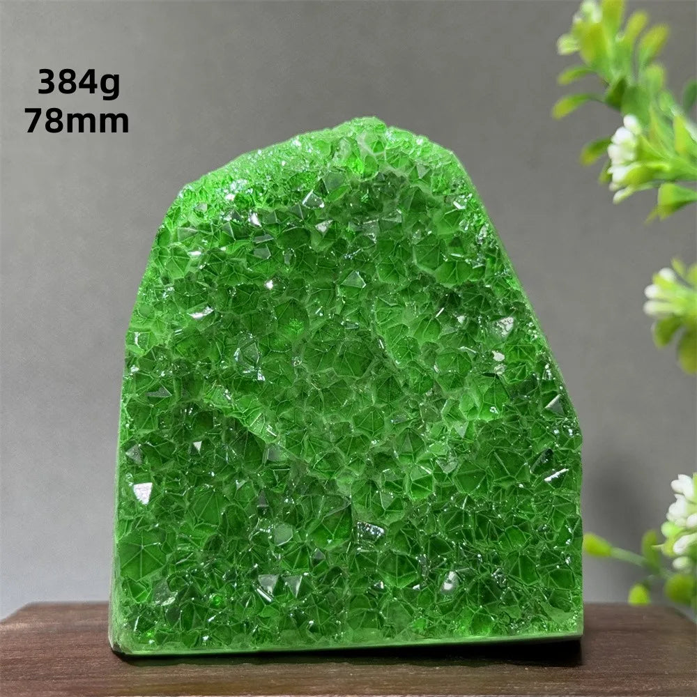 Green crystal rock on a wooden surface with a gray background