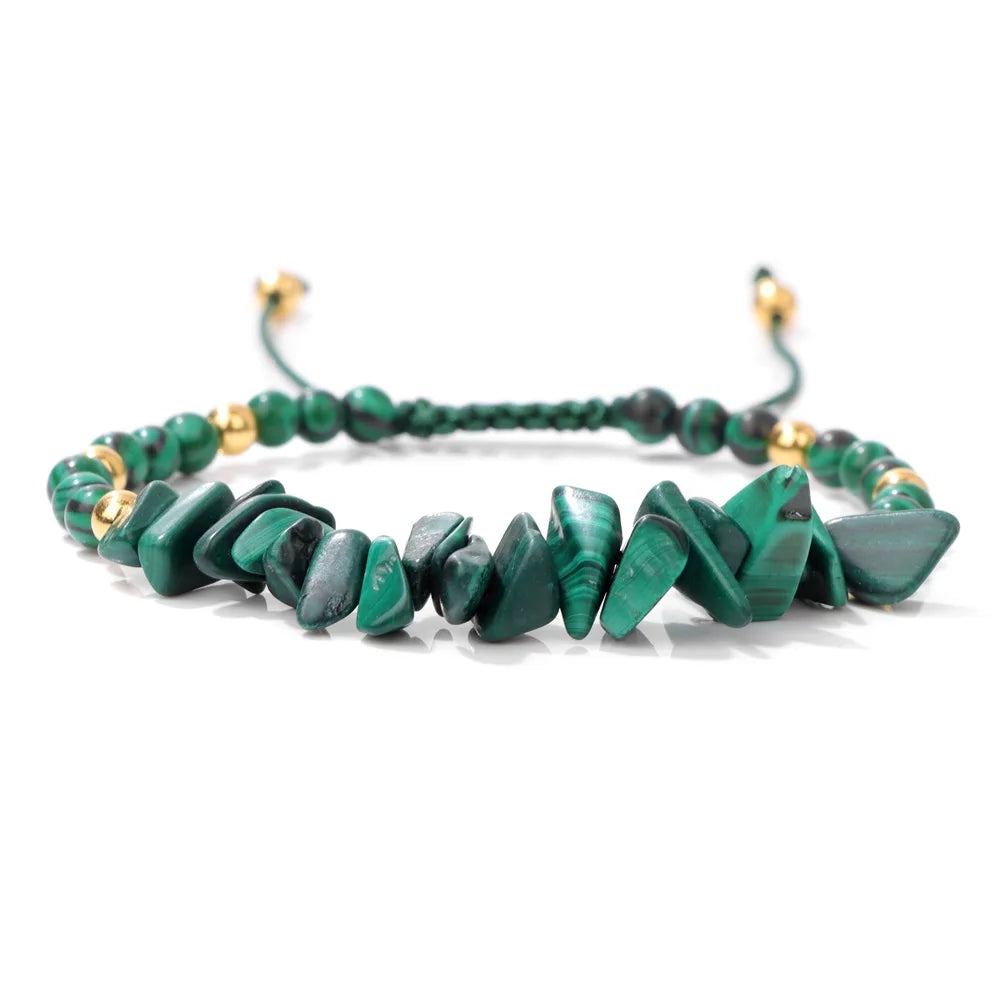 Green beaded bracelet with gold accents on a white background
