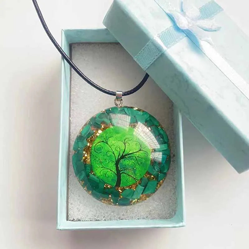 Green tree pendant necklace in a light blue box on a white background