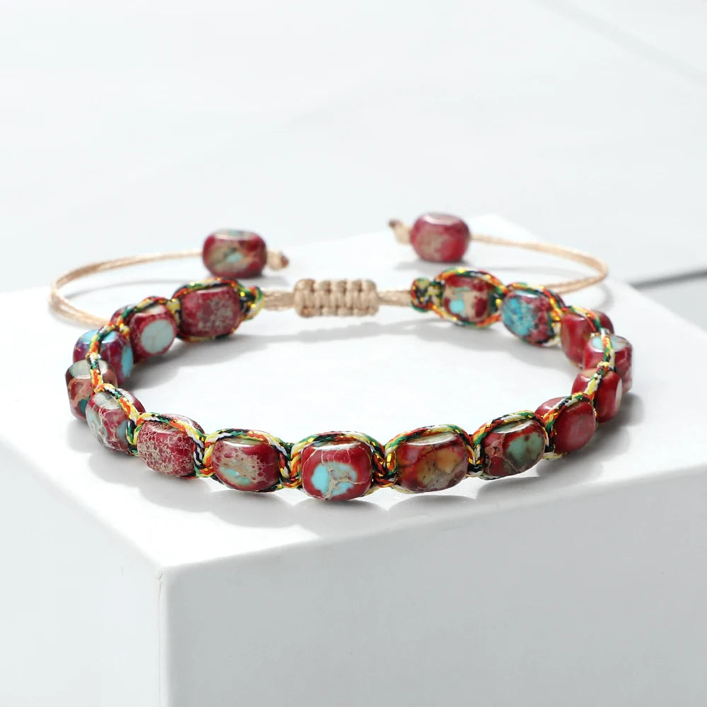 Beaded bracelet with red and multicolored beads on a white surface