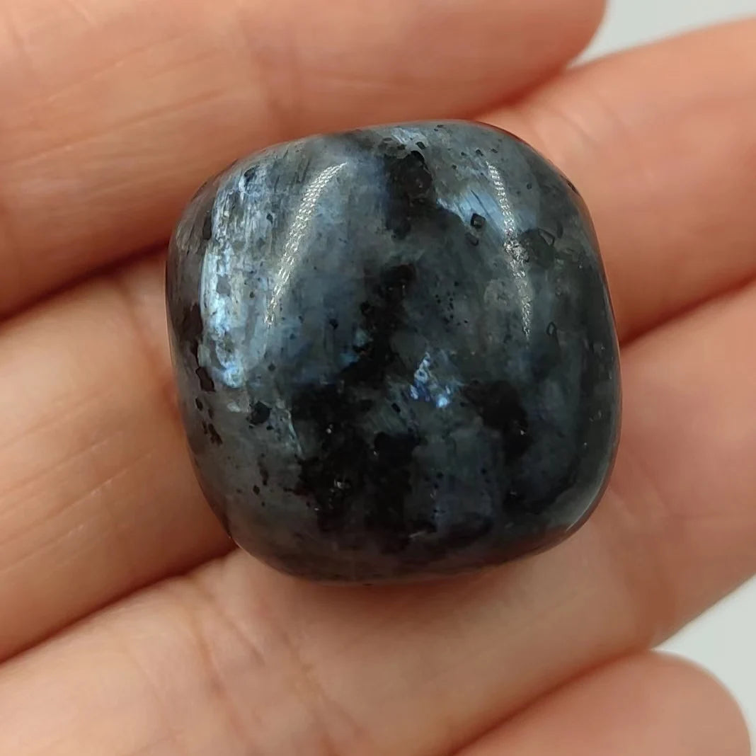 Polished blue stone held in a hand
