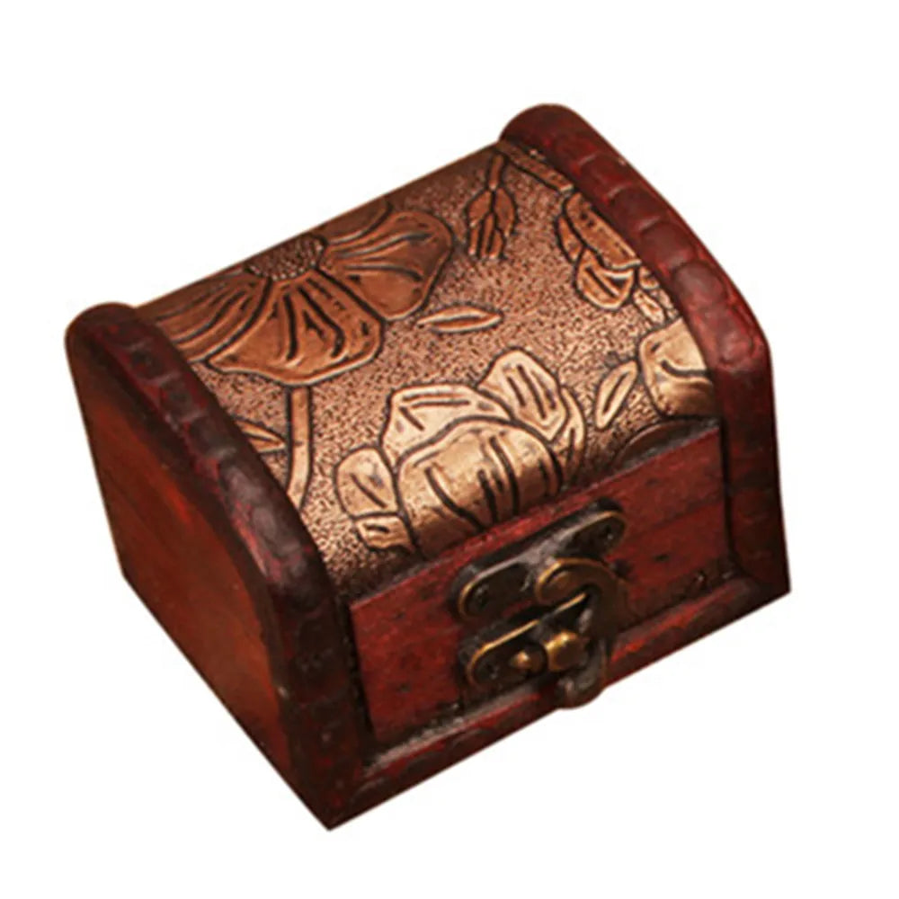 Wooden jewelry box with floral embossing and a lock on a white background