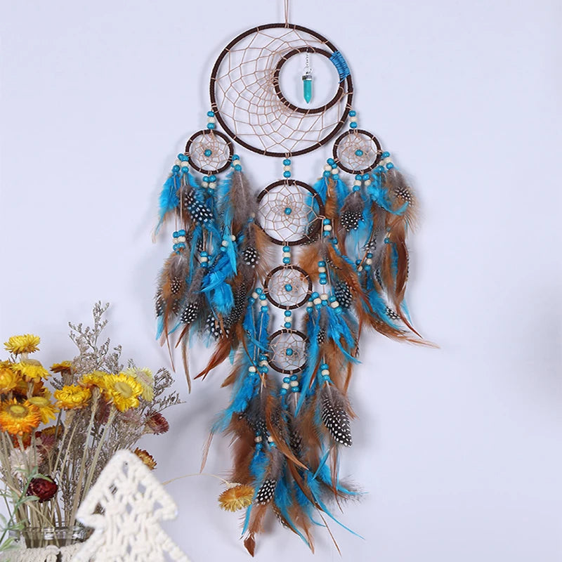 Decorative dreamcatcher with feathers and beads on a white background