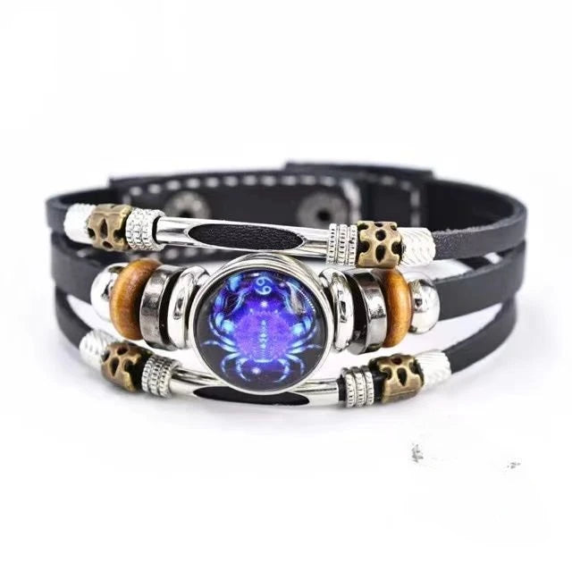 Multistrand bracelet with a central purple gemstone on a white background