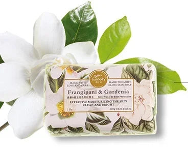 Bar of soap with floral design and green leaves on a white background