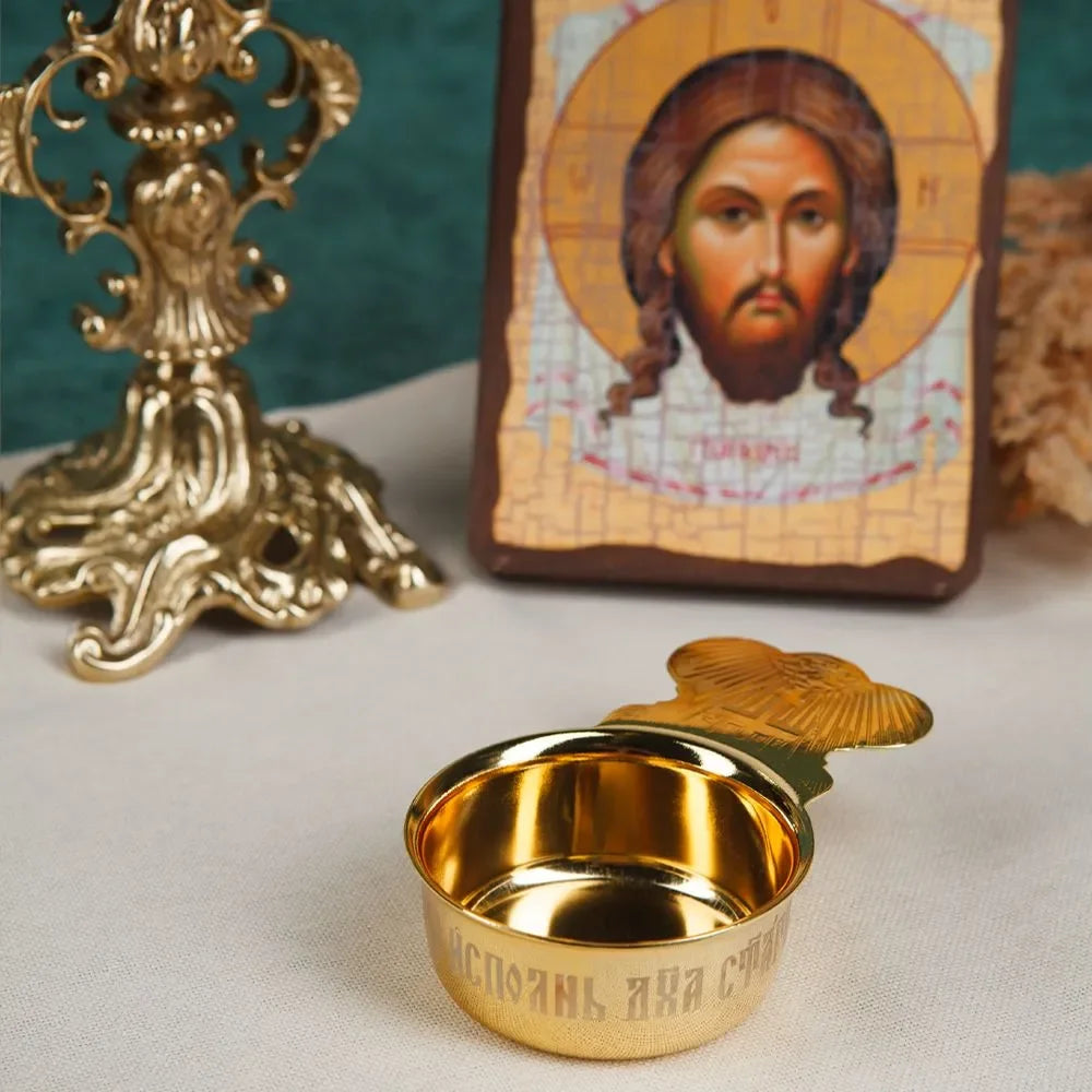 Gold cup with a religious icon in the background